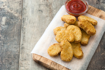 Fried chicken nuggets on wooden table
