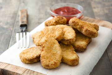 Fried chicken nuggets on wooden table

