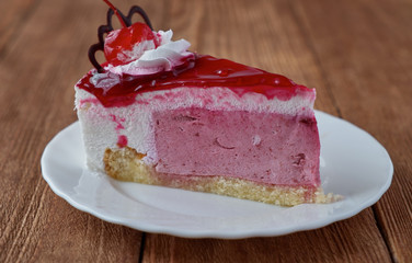 Delicious cake dessert with cream, cherry and coffee