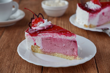 Delicious cake dessert with cream, cherry and coffee