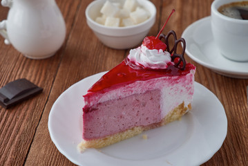 Delicious cake dessert with cream, cherry and coffee
