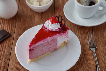 Delicious cake dessert with cream, cherry and coffee