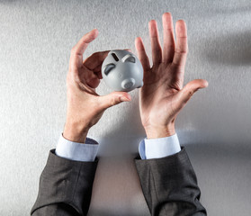 Fototapeta premium questioning businessman hands showing a money box for banking concept
