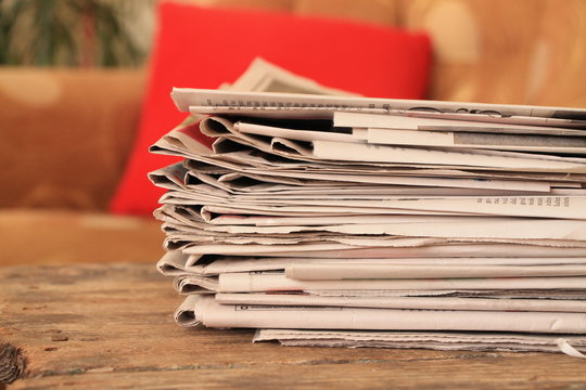 Newspapers on wooden table 