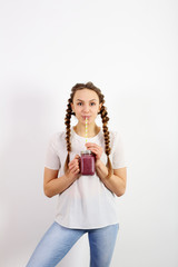 Young woman drinking blueberry smoothie, vitamins, health, utility and style
