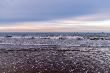 Waves on beach in sunset time. Baltic sea, Gdansk.