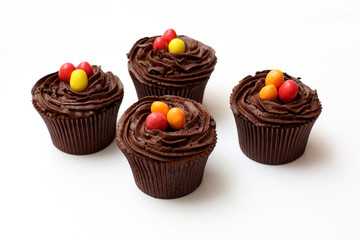 Easter cupcakes decorated with nest chocolate cream and sugar eggs on a white  background