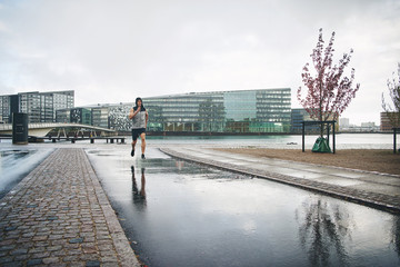 Man running in city after rain