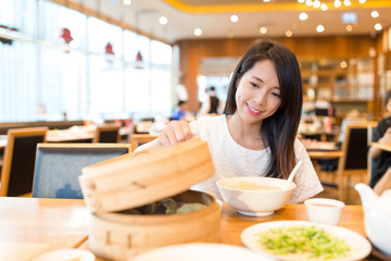 Woman enjoy the meal in chinese restaurant