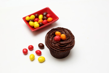 Easter cupcakes decorated with nest chocolate cream and sugar eggs on a white  background