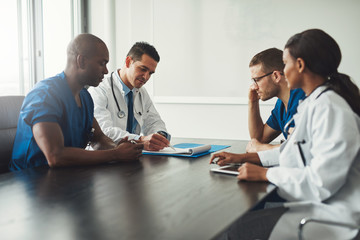 Multiracial medical team having a meeting - Powered by Adobe