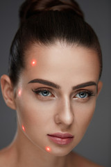 Closeup Of Beautiful Woman Face With Laser Points On Facial Skin
