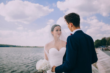 Elegant young bride and groom on the beach