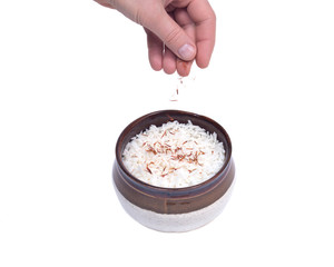 Cooked rice in ceramic bowl with saffron isolated on white background