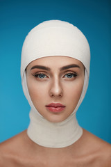 Woman Face With Smooth Soft Skin And Perfect Makeup In Bandages