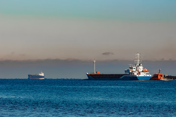 Blue cargo ship leaving Riga and entering Baltic sea