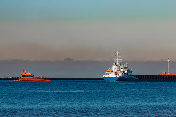Fototapeta premium Blue cargo ship leaving Riga and entering Baltic sea