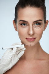 Treatment. Beautician Drawing Surgical Lines On Woman Face
