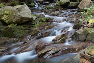 Naklejka na ściany i meble mountain stream on a long exposure