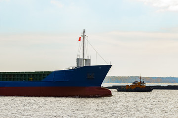 Blue cargo ship's bow leaving the port of Riga