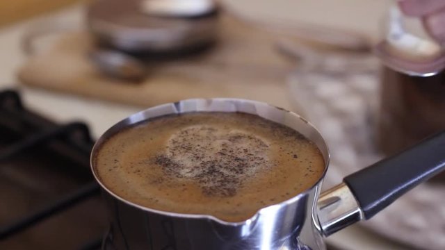 Slowmotion adding sugar in coffee and stirring
