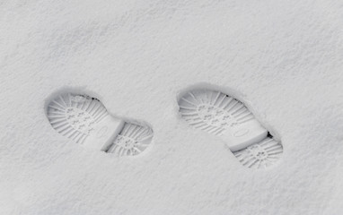 Footsteps in the snow, boot mark close up outdoor