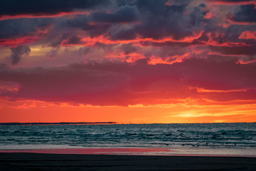 Red cloudy sunset sky over the Baltic sea