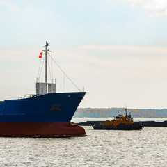 Fototapeta premium Blue cargo ship's bow leaving the port of Riga