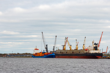 Fototapeta premium Black cargo ship loading in the port of Riga, Europe