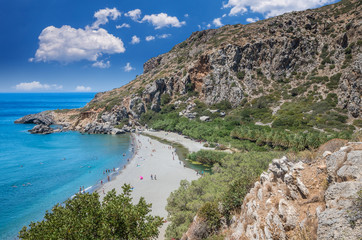 Fototapeta na wymiar Preveli Beach in Crete island, Greece. There is a palm forest and a river inside the gorge near this beach.