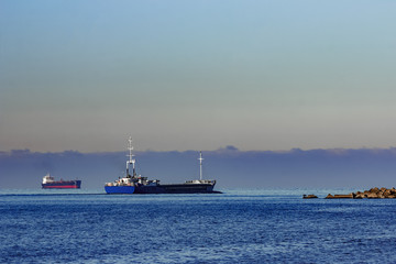 Blue cargo ship leaving Riga and entering Baltic sea