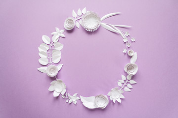 round frame with paper flowers on the purple background