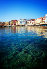 Fototapeta na wymiar clear turqiouse water of Chania habour, Crete, Greece, retro toned