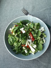 Spinach salad with raw broccoli and cauliflower.