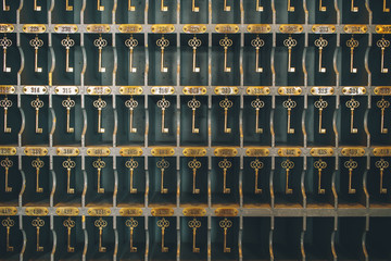 Hotel keys hanging on hooks at hotel