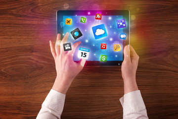 hands holding tablet