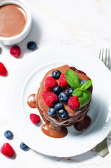 chocolate pancake with blueberries, raspberies and chocolate sauce