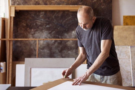Male artist working in workshop
