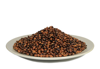 Pile of Roasted Barley for Brewing Barley Tea, in a White Plate on White Background 