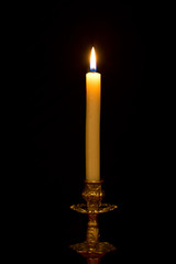 Chandelier with burning candle on black background