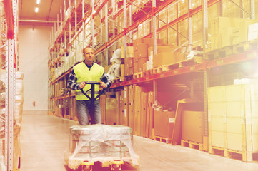 man carrying loader with goods at warehouse
