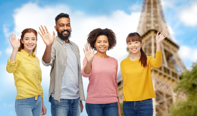 international group of happy people waving hands