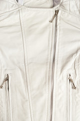 White leather jacket on white background. Leather jacket macro details. Jacket zippers and pockets