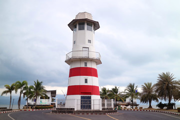 Coastal Lighthouse against Gray Cloudy Sky 