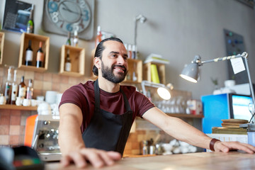 happy man or waiter at bar or coffee shop