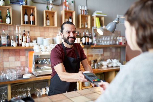 Man Or Waiter With Card Reader And Customer At Bar