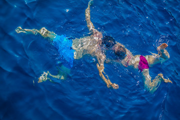 couple making love in the sea, kissing underwater in turquoise blue sea