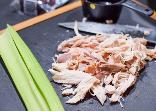 Cut Up Rotisserie Chicken On A Cutting Board Ready To Go Into A Casserole With Celery