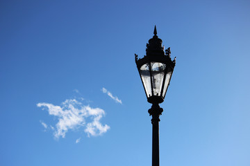 Fototapeta na wymiar Lantern in the park in the spring sunlit by the sun