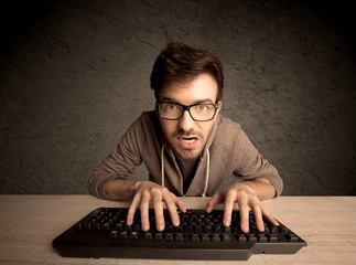Computer geek typing on keyboard